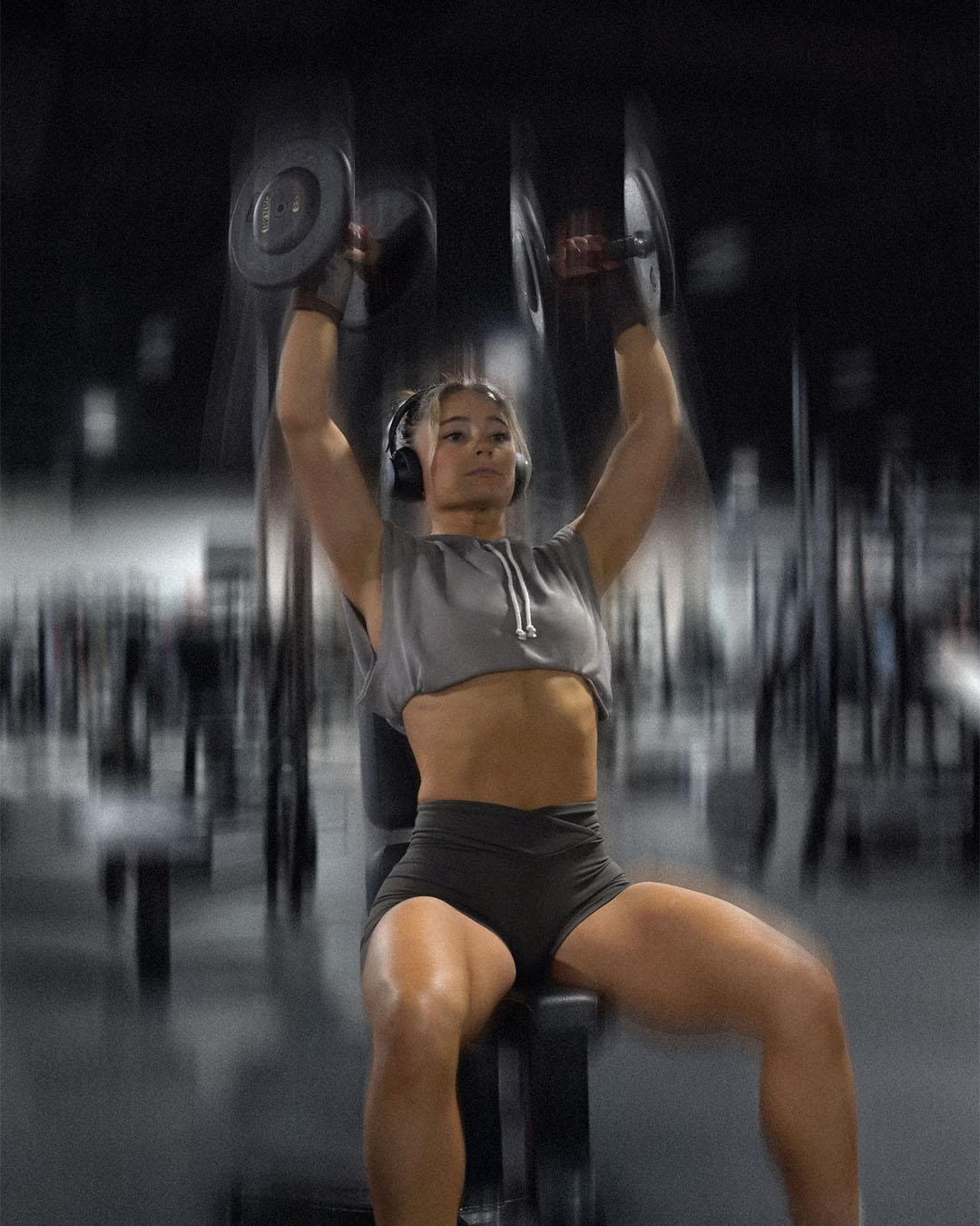 woman doing shoulder press wearing uppper wrist wraps