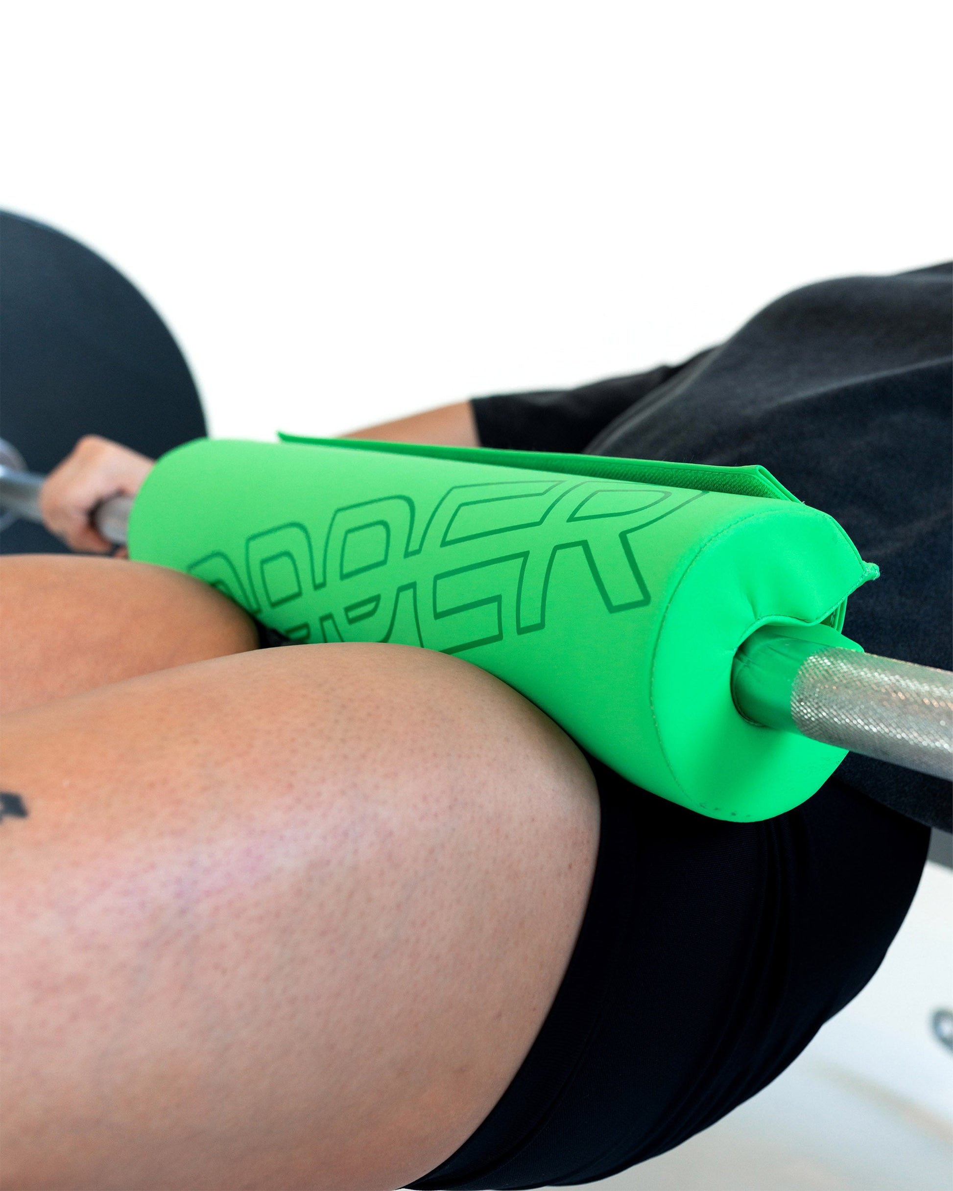 close-up of neon green uppper barbell pad shown wrapped around a barbell during exercise