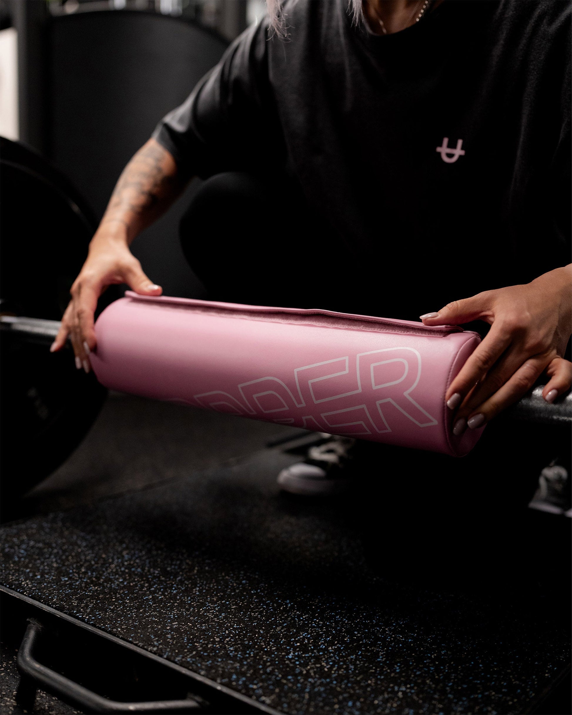 close-up of pink uppper barbell pad showing foam density and uppper logo