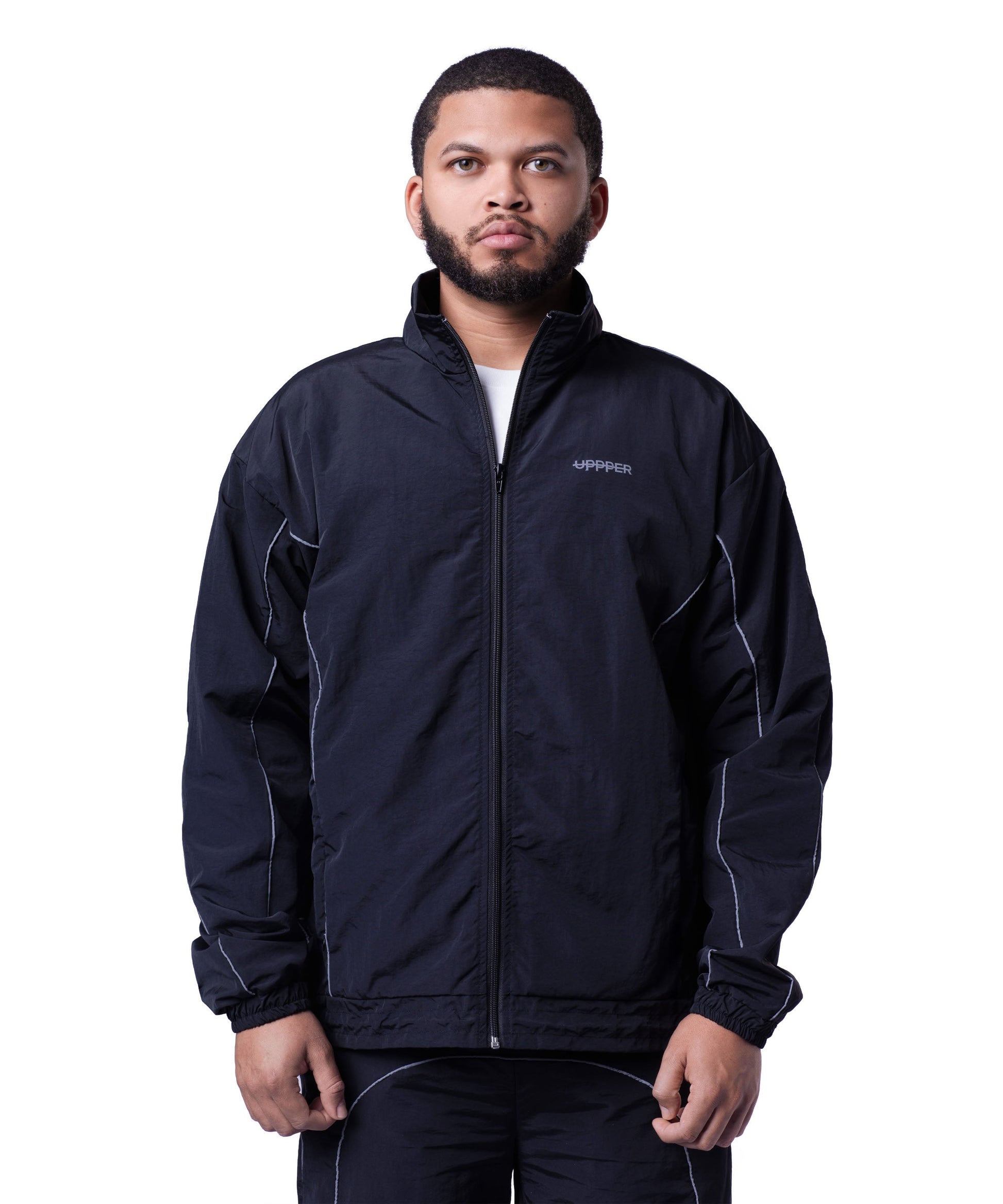 front of black uppper track jacket with reflective stripe detail on white background