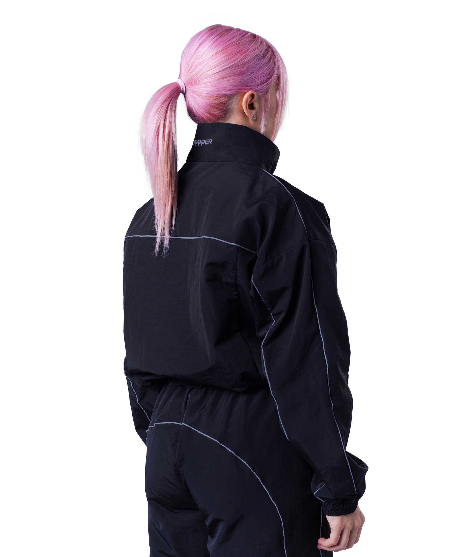 back of black uppper track jacket showing reflective lines on white background
