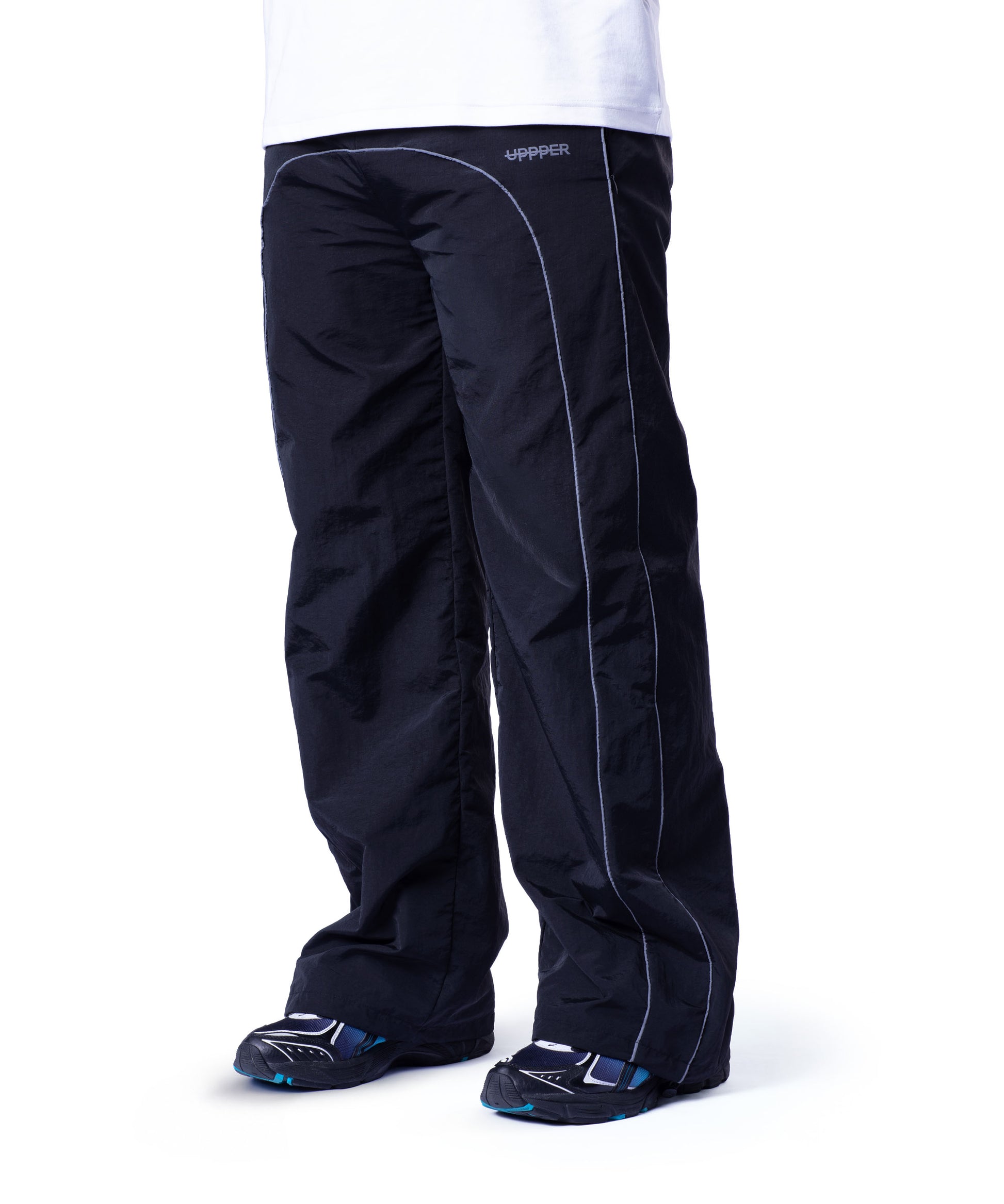 front of black uppper track pants with reflective stripe detail on white background