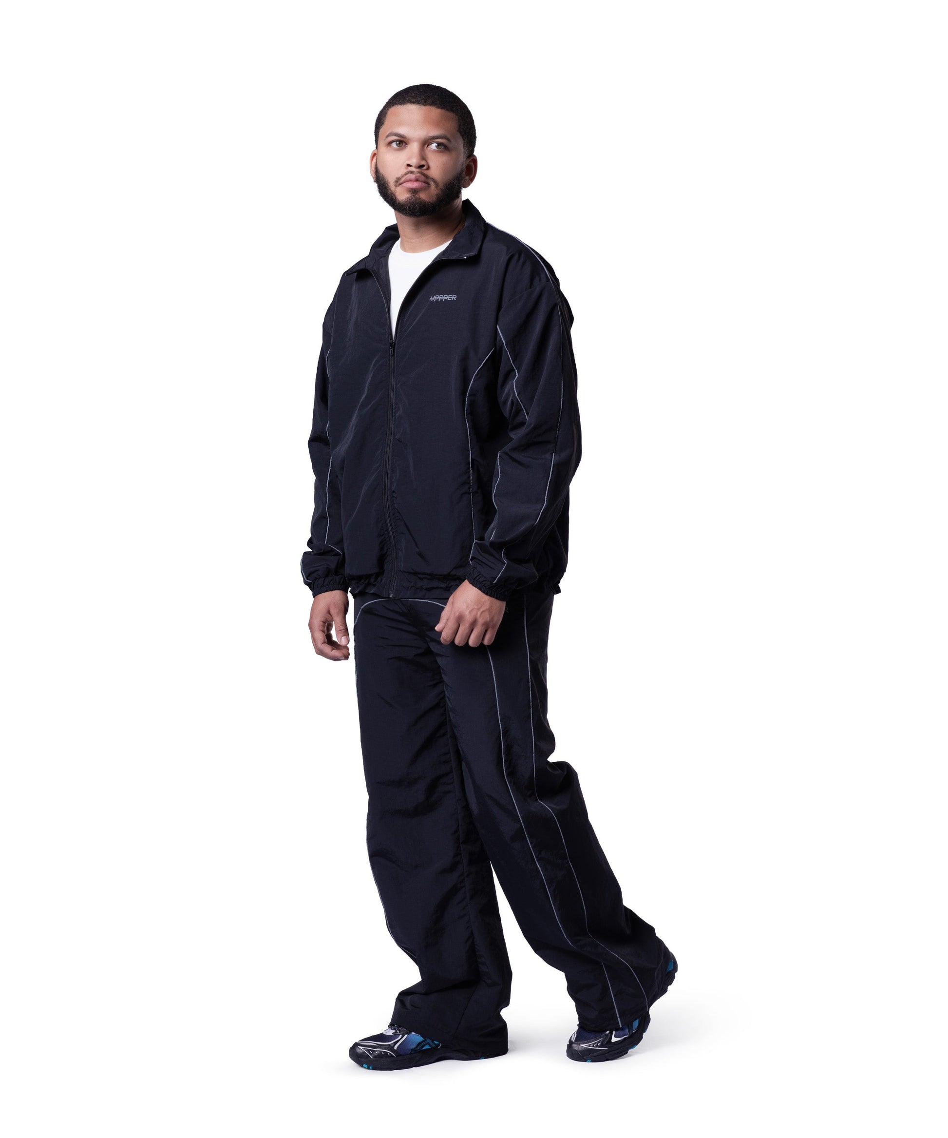 model wearing black uppper track jacket lifestyle shot