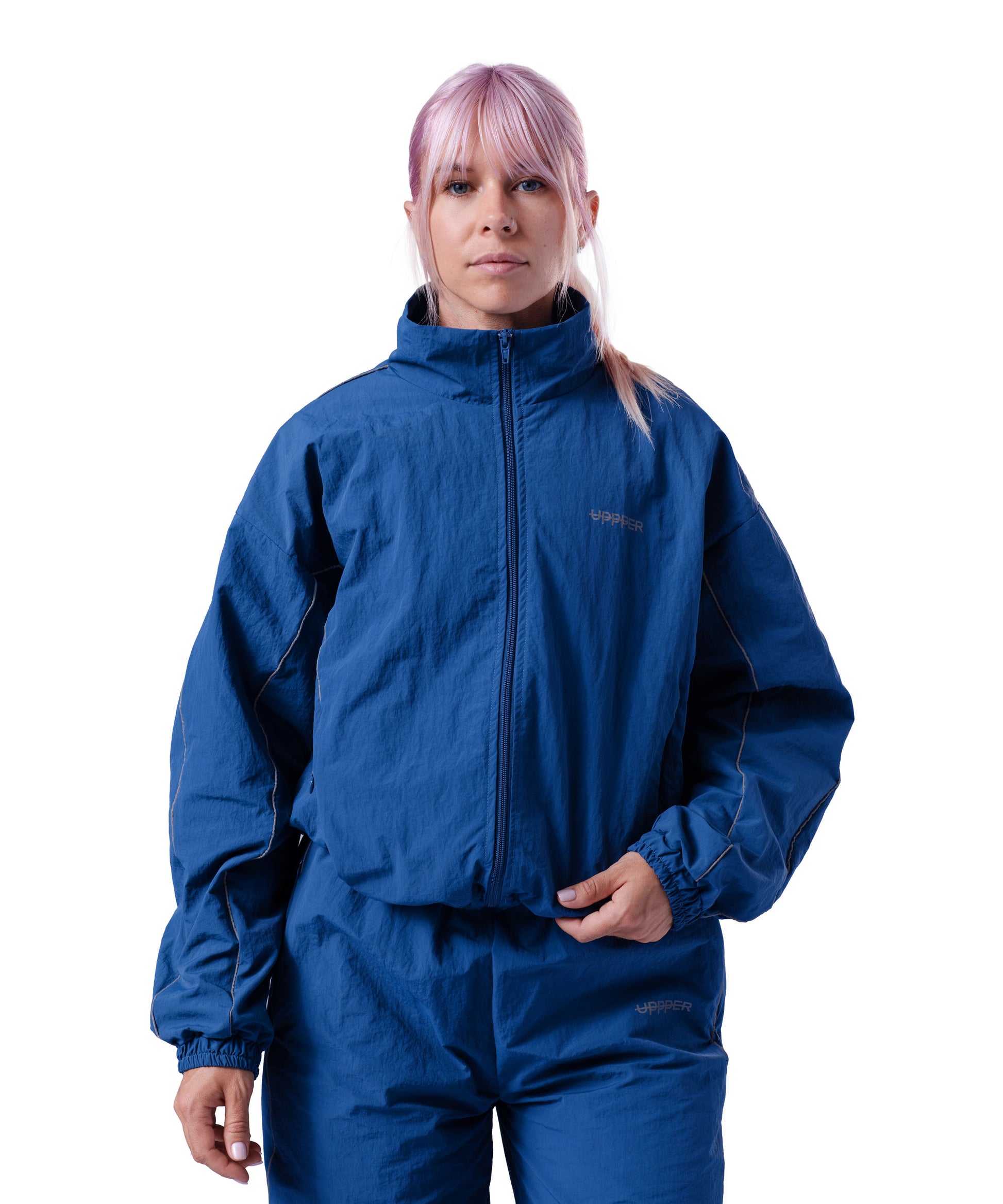 front of blue uppper track jacket with reflective stripe detail on white background