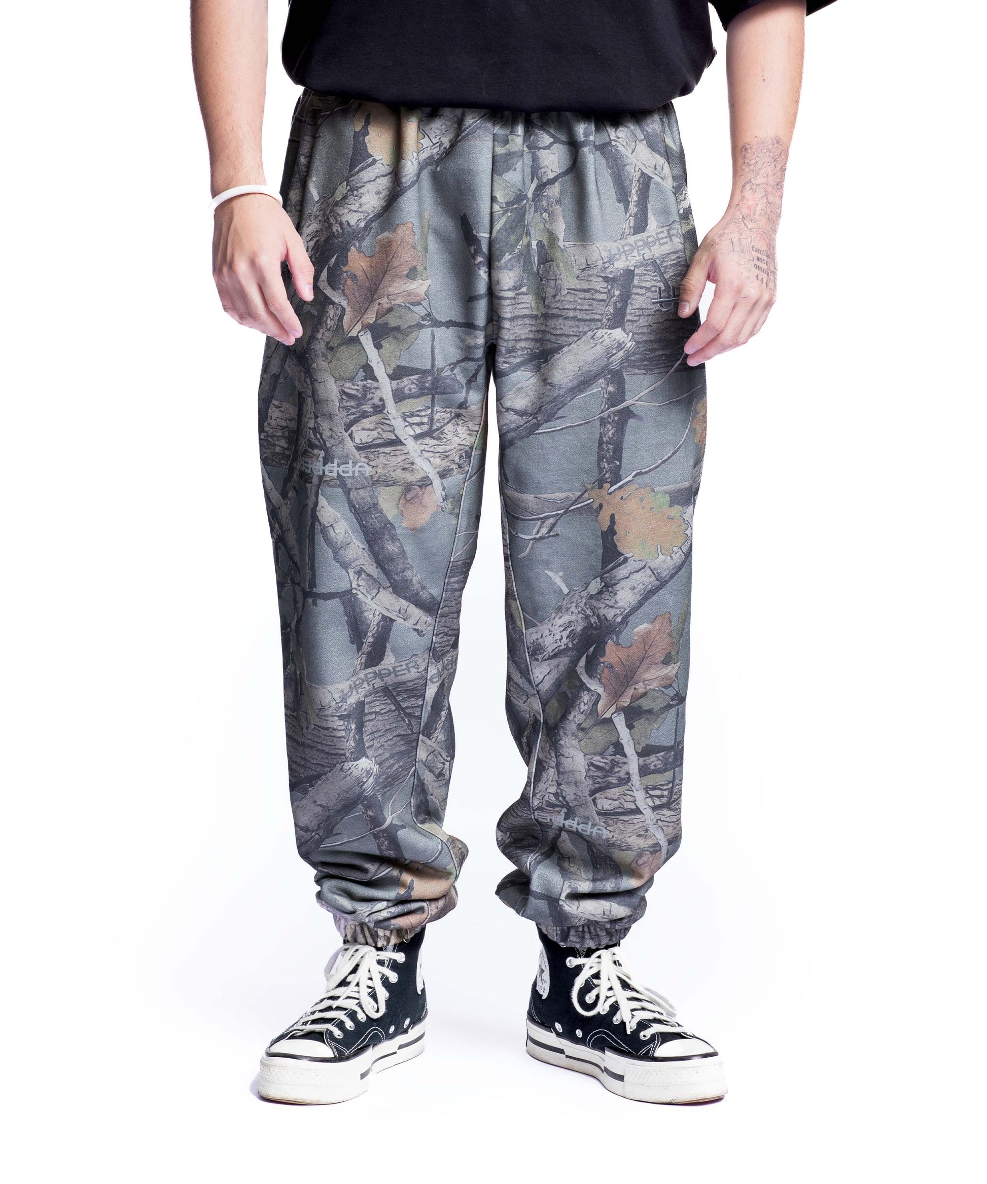 model wearing camo uppper sweatpants mens showing full leg from waist down on white background
