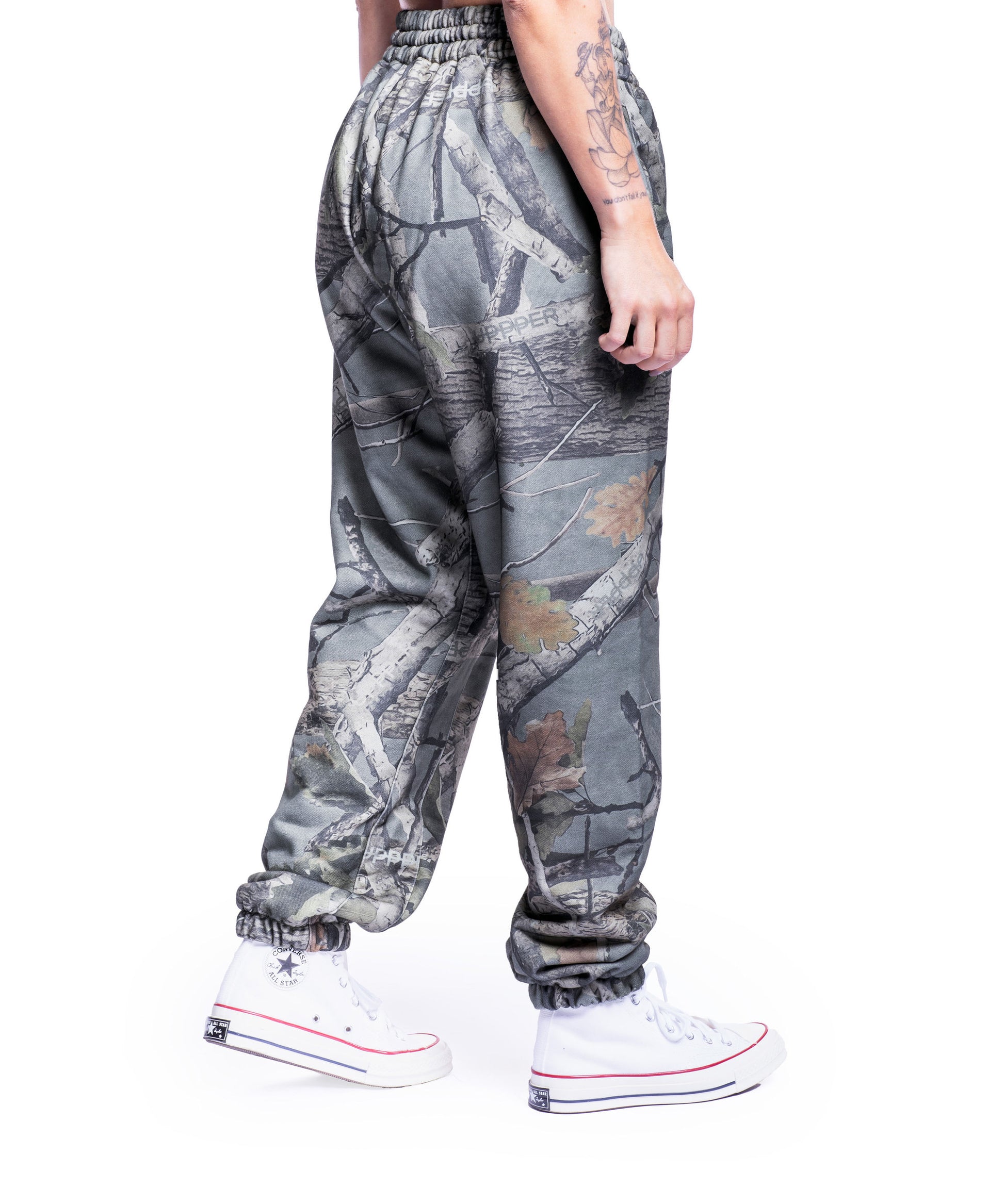 close-up of camo uppper sweatpants showing waistband and logo detail