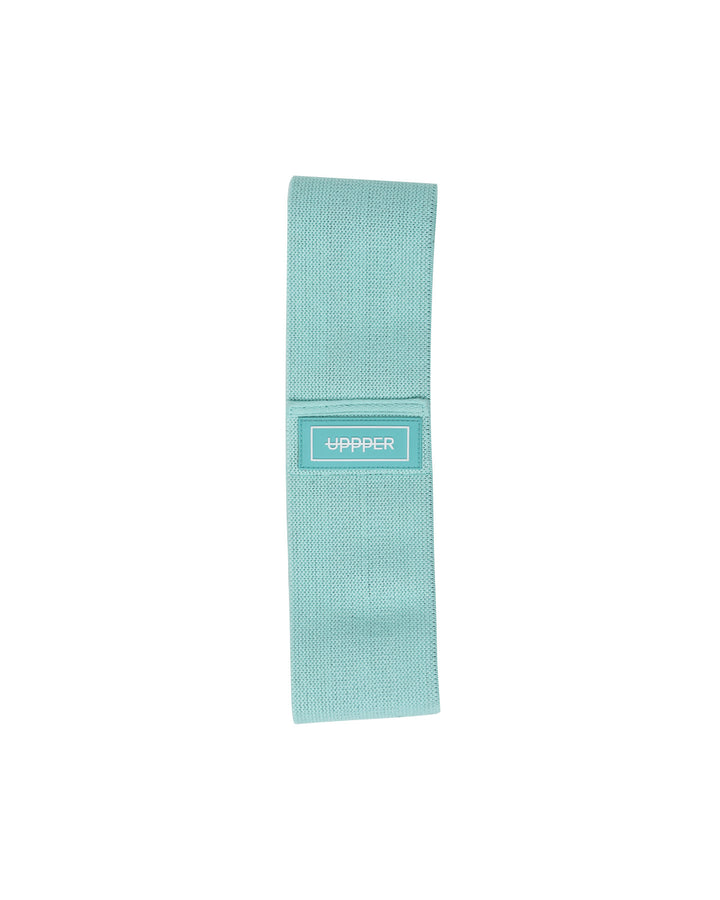 tan uppper fabric hip resistance band laid flat with uppper label on white background