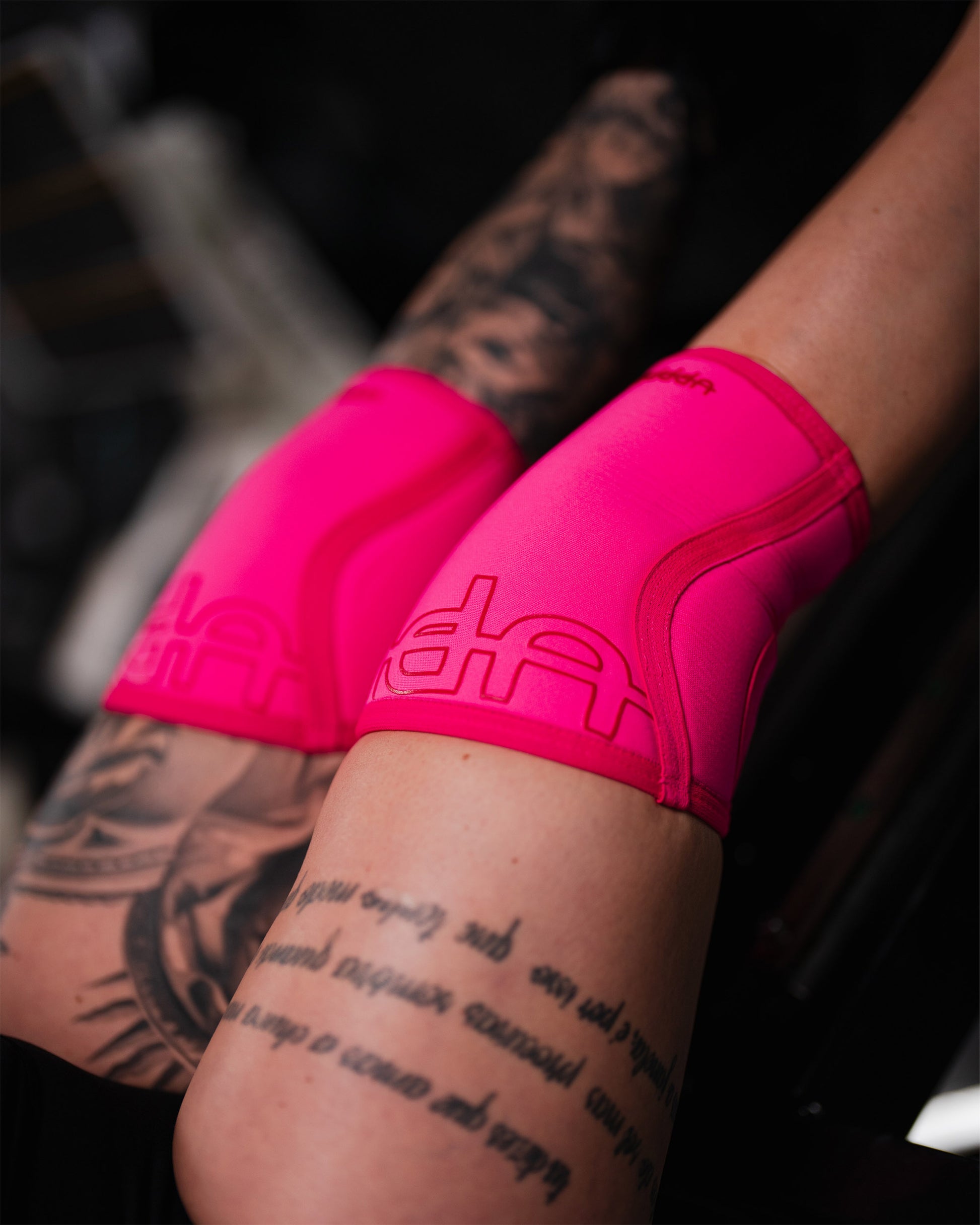 neon pink uppper knee sleeves worn on knees during training