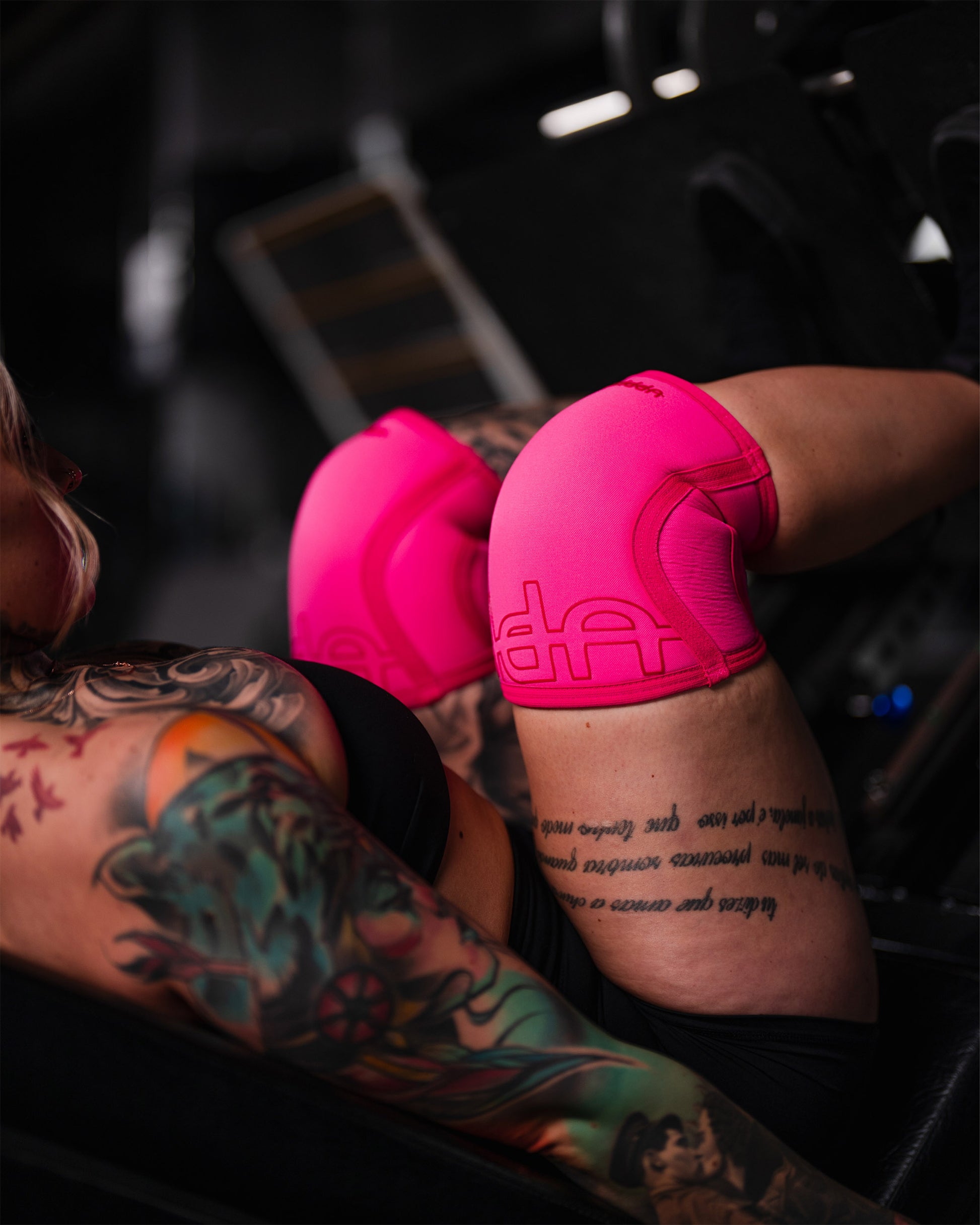 neon pink uppper knee sleeves worn on knees during training
