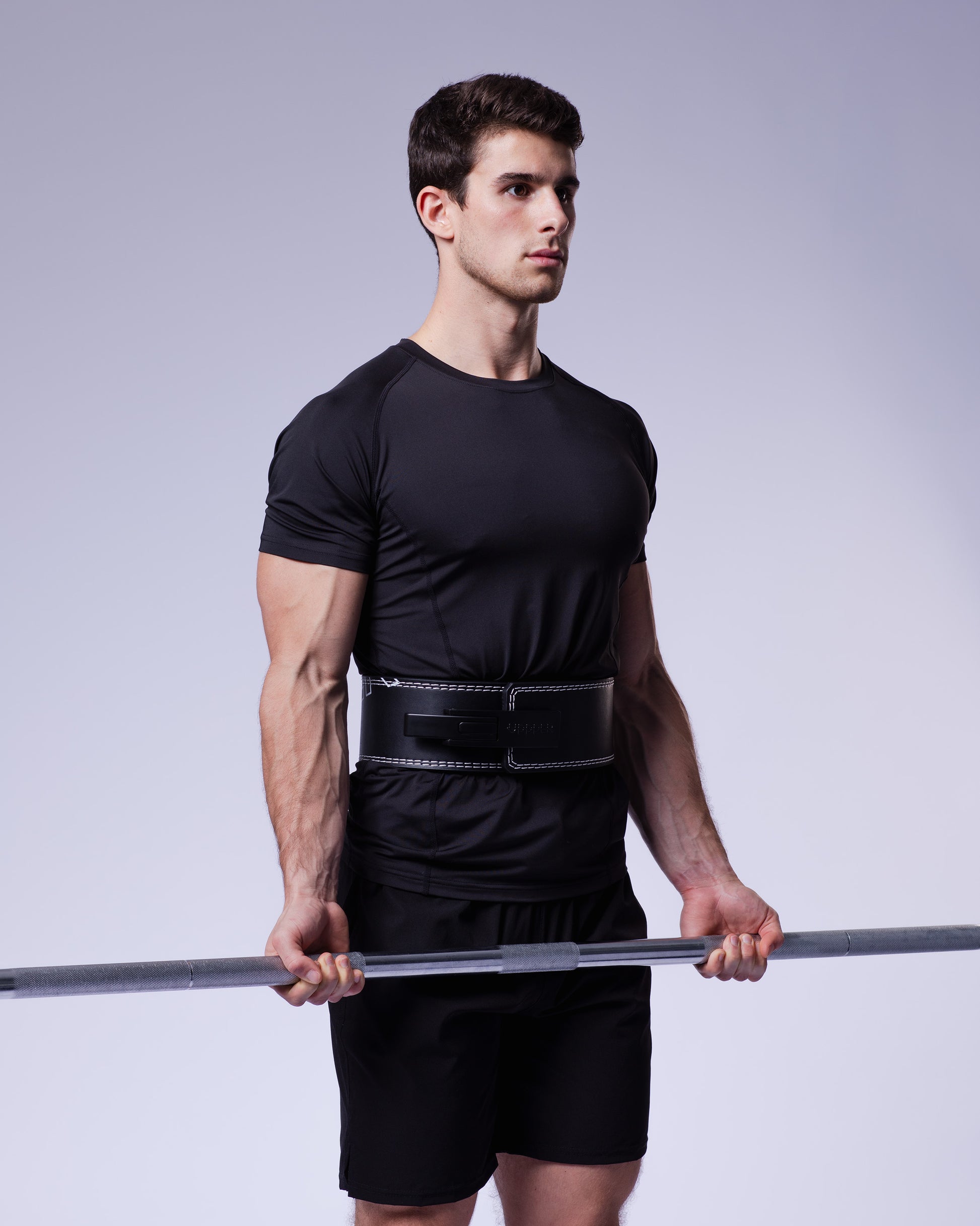 athlete holding bar wearing black uppper lever belt