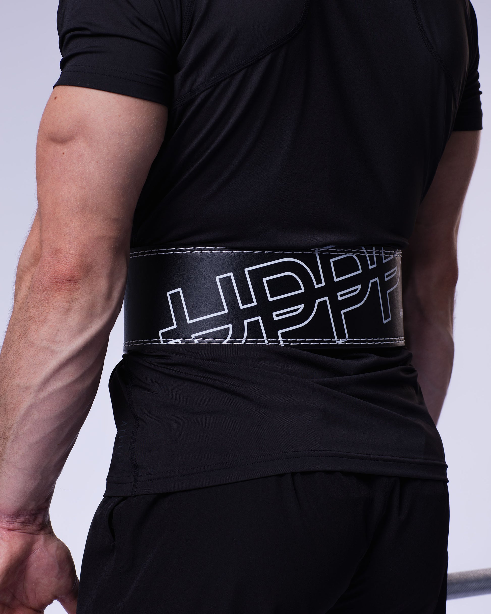 black uppper lever belt close-up showing logo