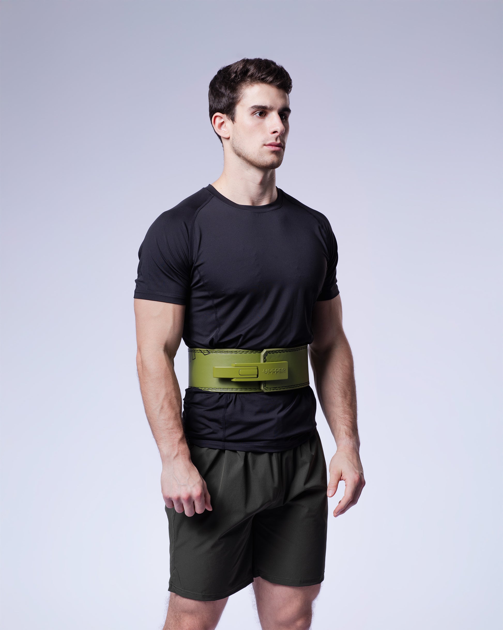 athlete wearing khaki uppper lever belt on grey background