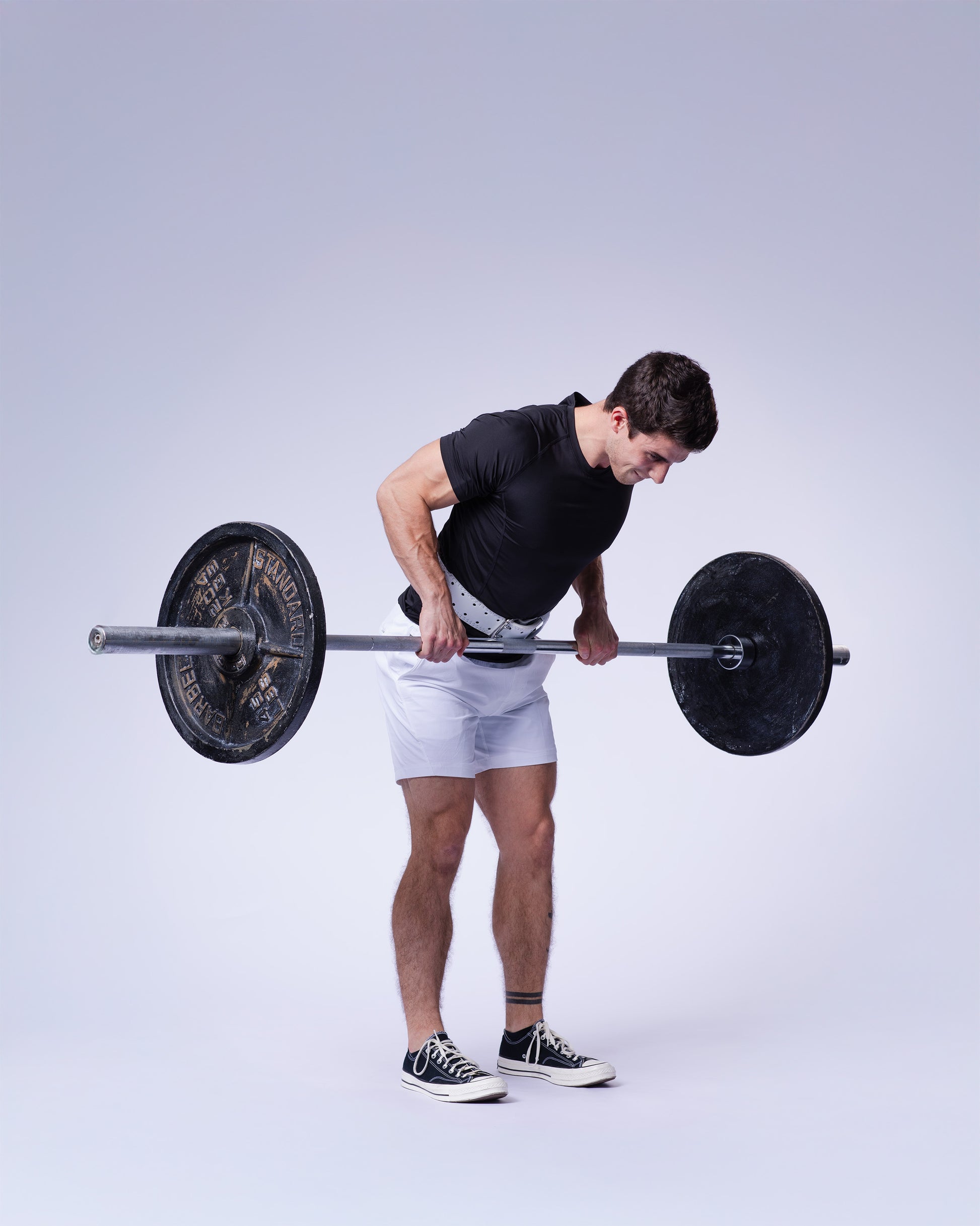 athlete performing  exercise in white uppper lifting belt