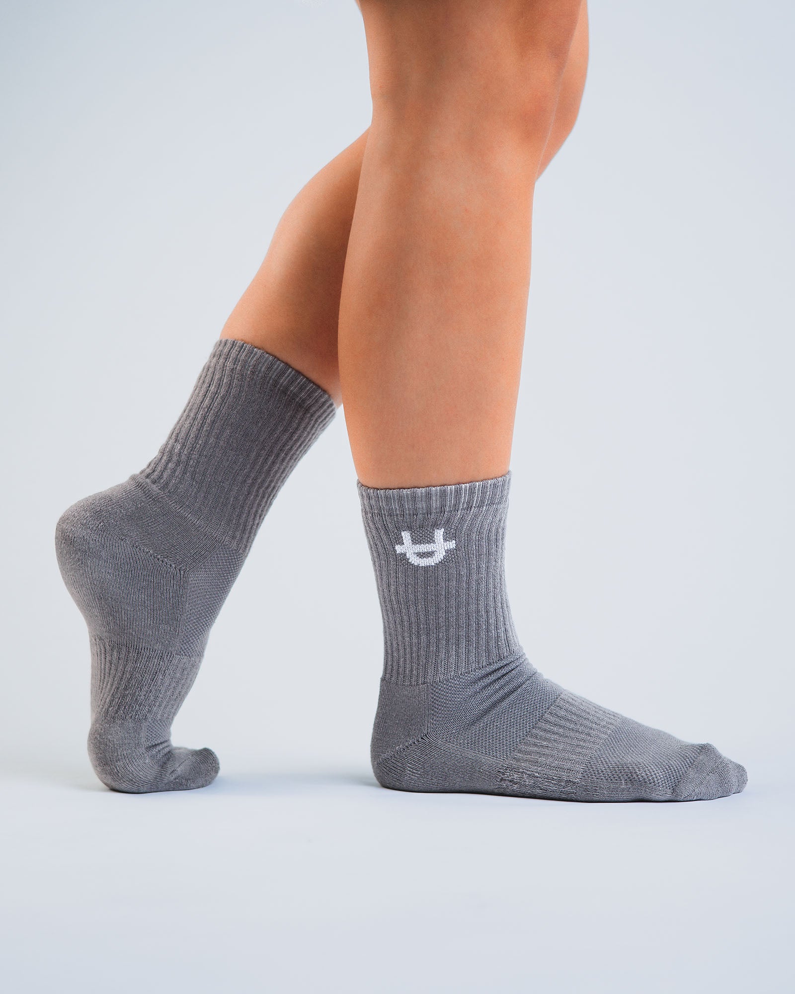 grey uppper crew socks worn on feet showing fit and logo detail