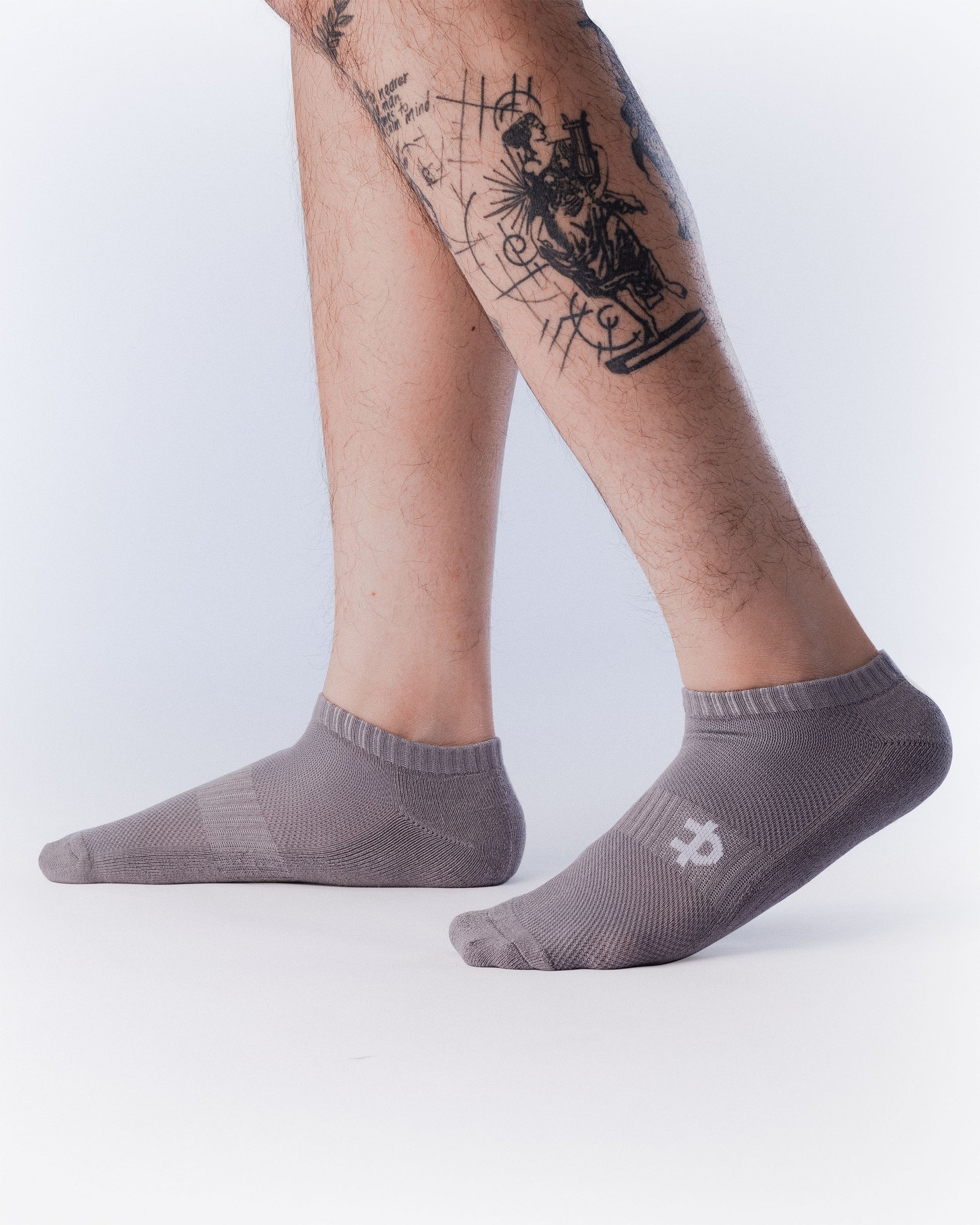 grey uppper low-cut socks worn on feet showing fit and logo detail