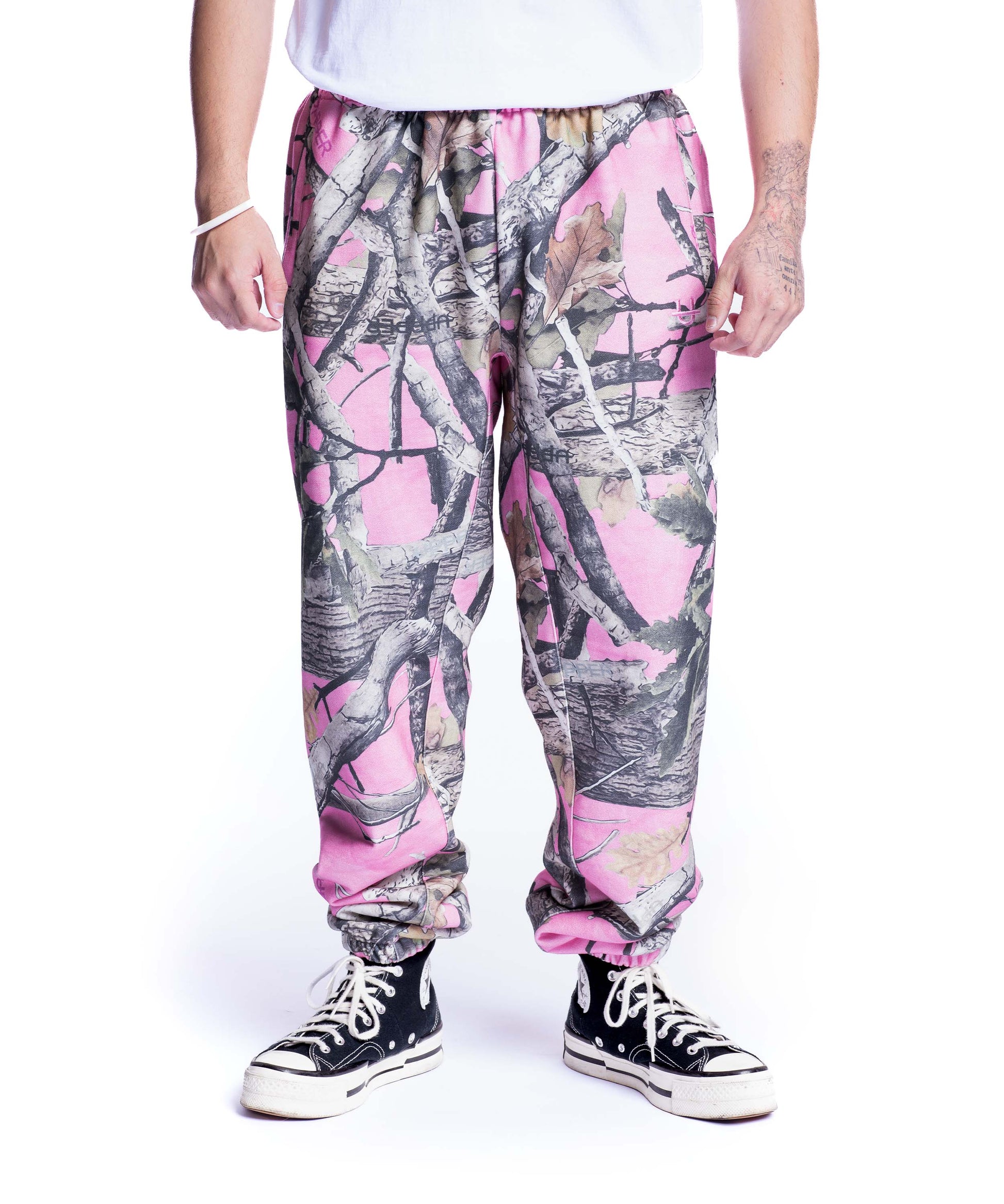 model wearing pink camo uppper sweatpants mens showing full leg on white background