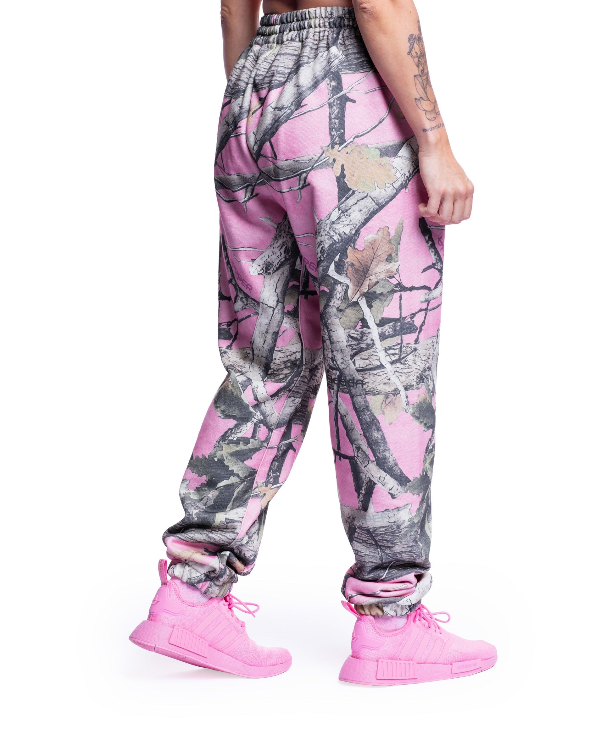 close-up of pink camo uppper sweatpants showing waistband and logo detail