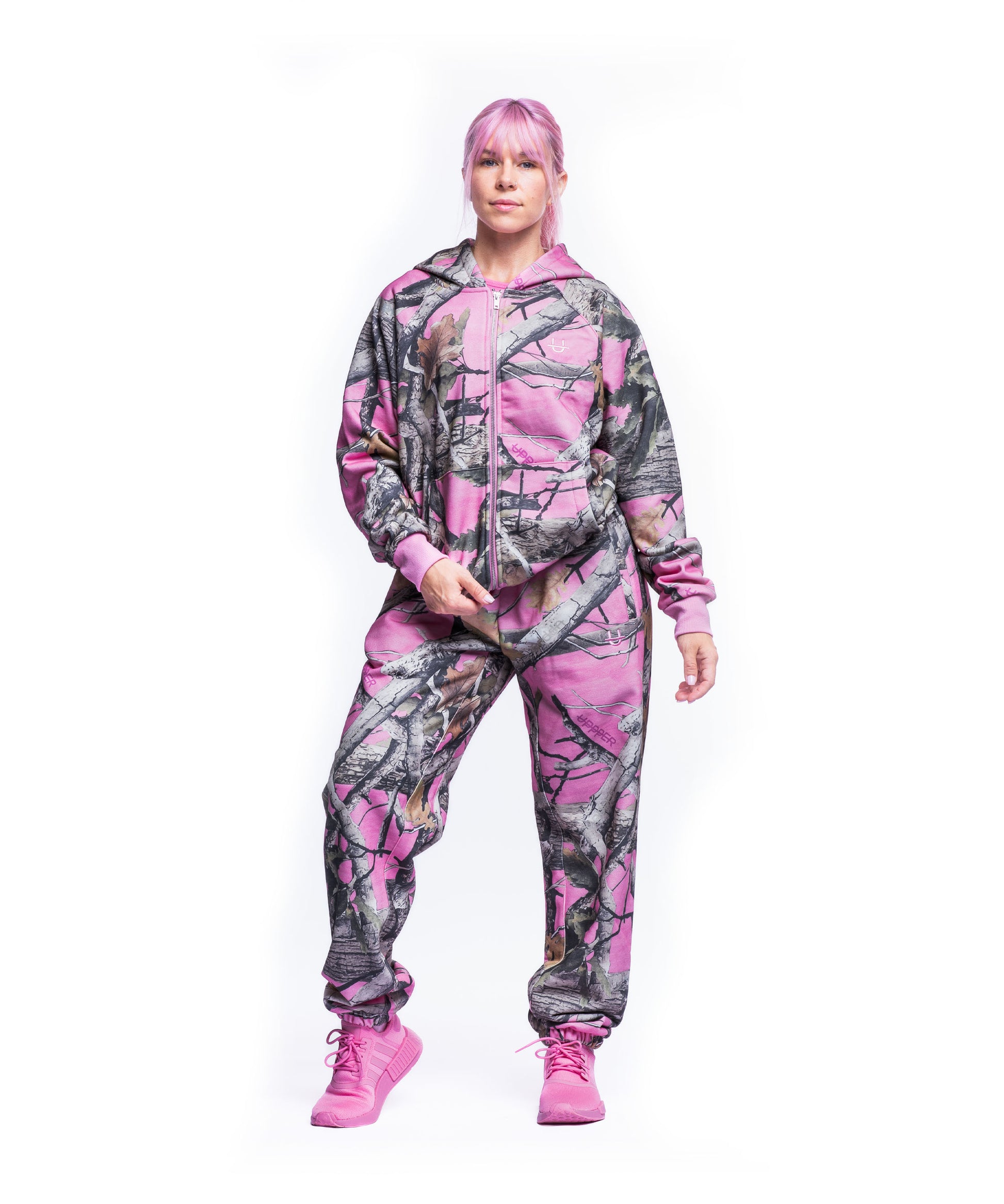 model wearing pink camo uppper sweatsuit on white background