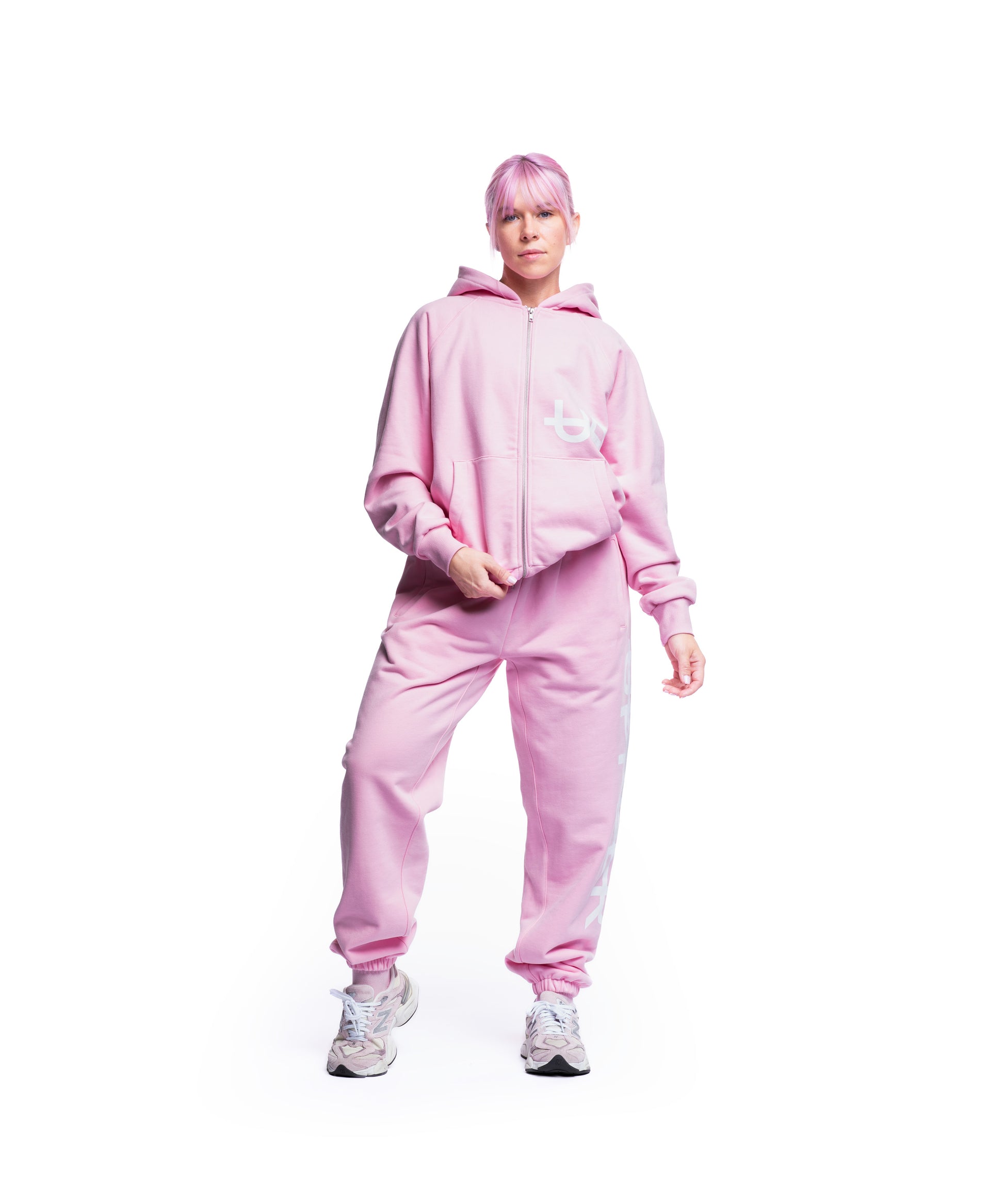 woman wearing pink uppper sweatsuit with side logo