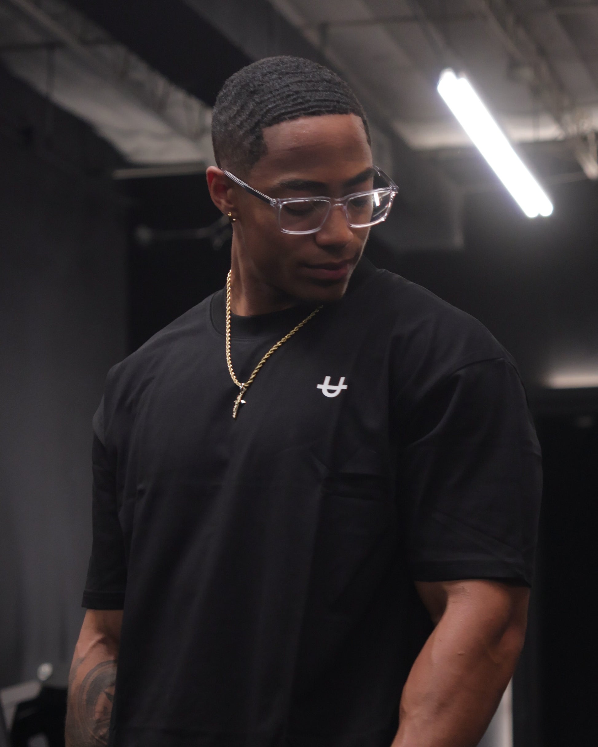 athlete wearing black uppper core t-shirt in gym