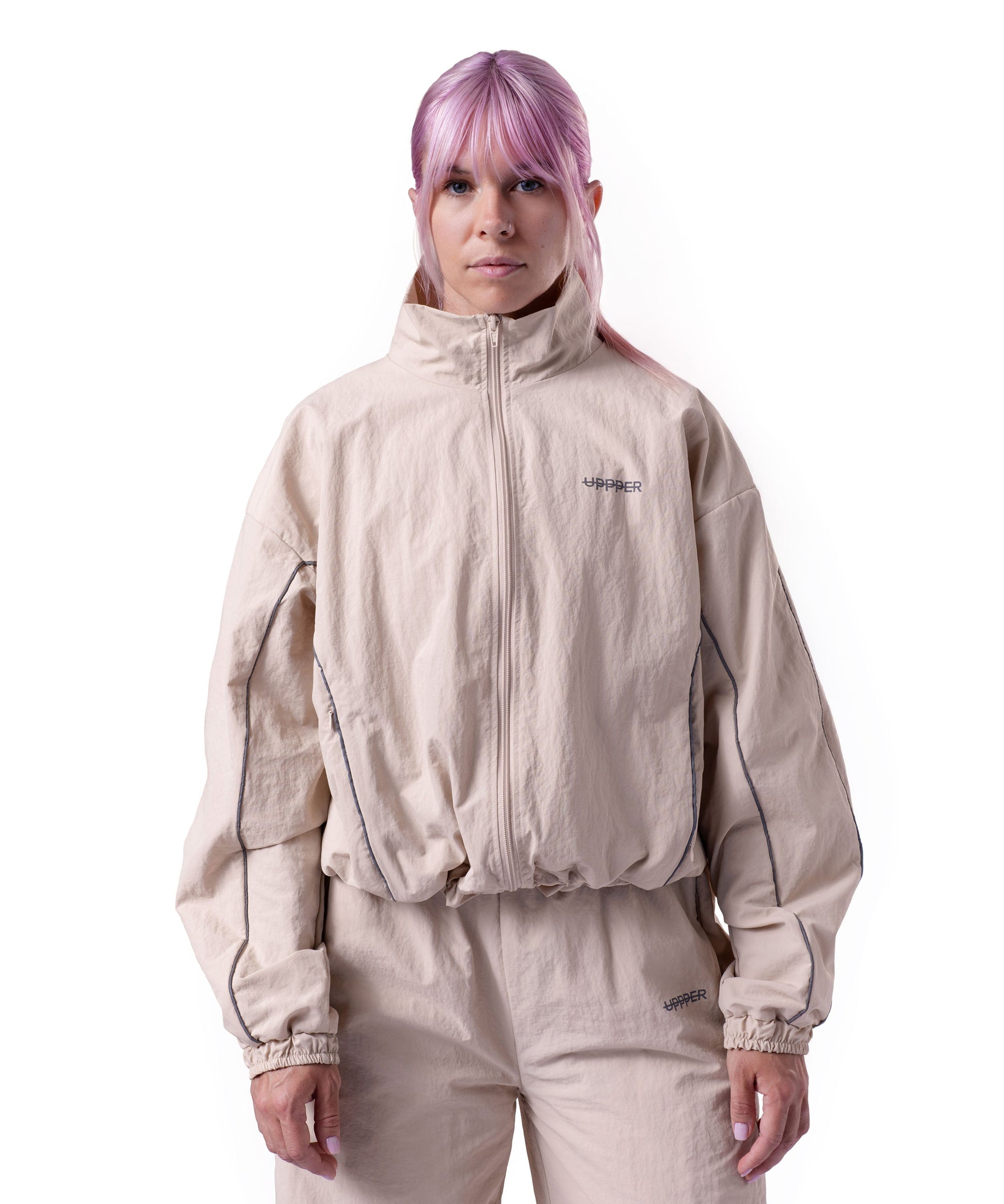front of tan uppper track jacket with reflective stripe detail on white background