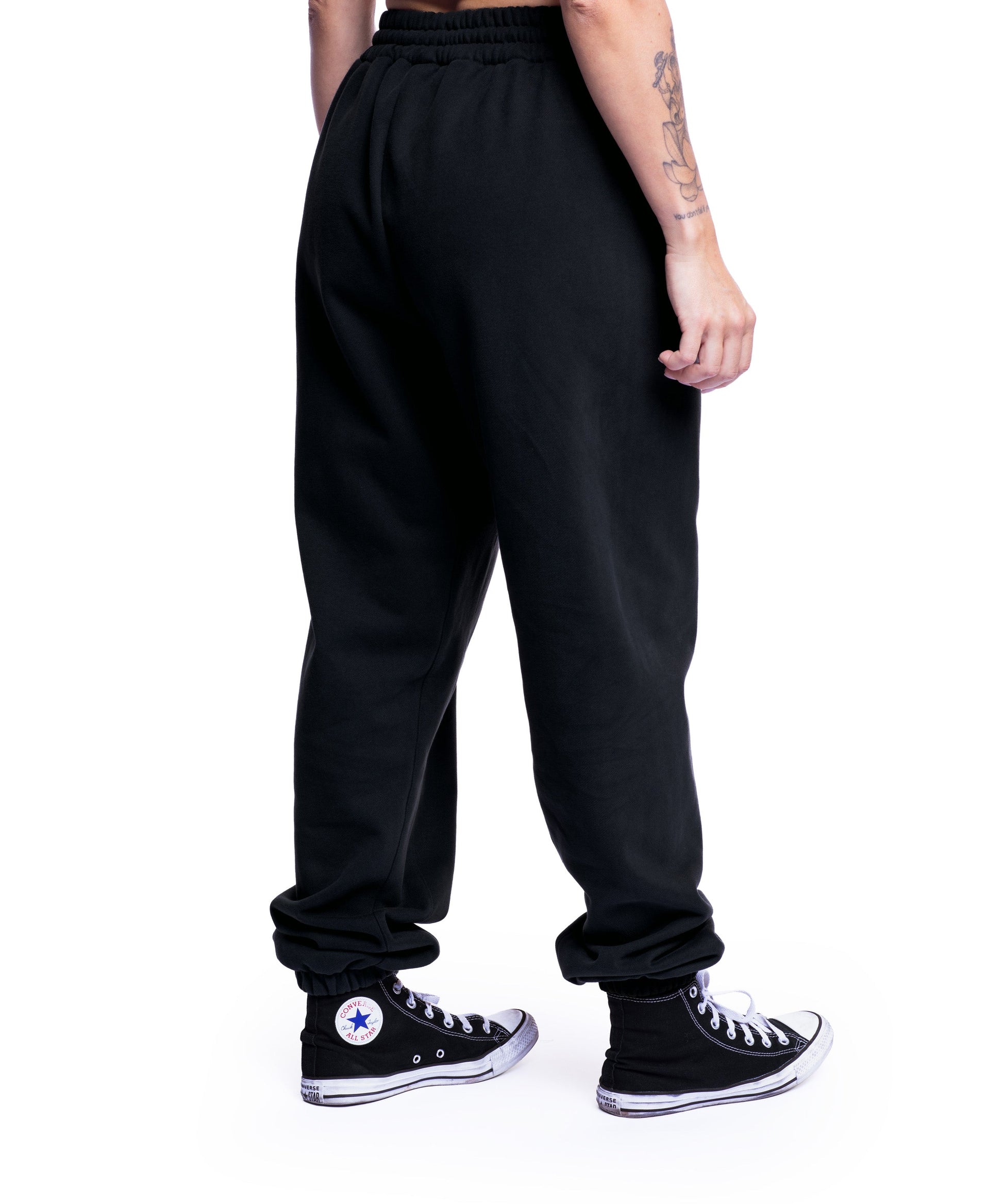 close-up of washed black uppper sweatpants showing waistband and logo detail