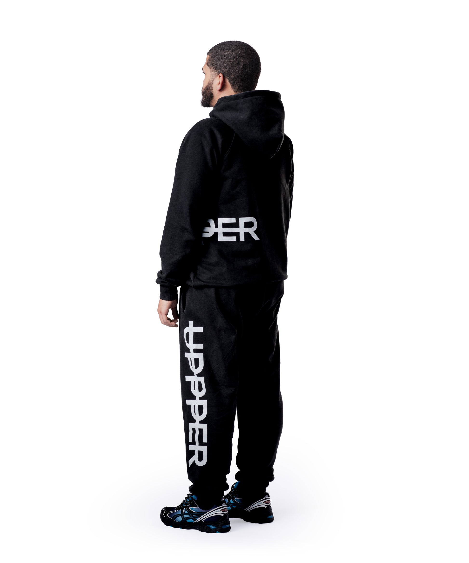 model showing back of washed black uppper sweatsuit with oversized logo