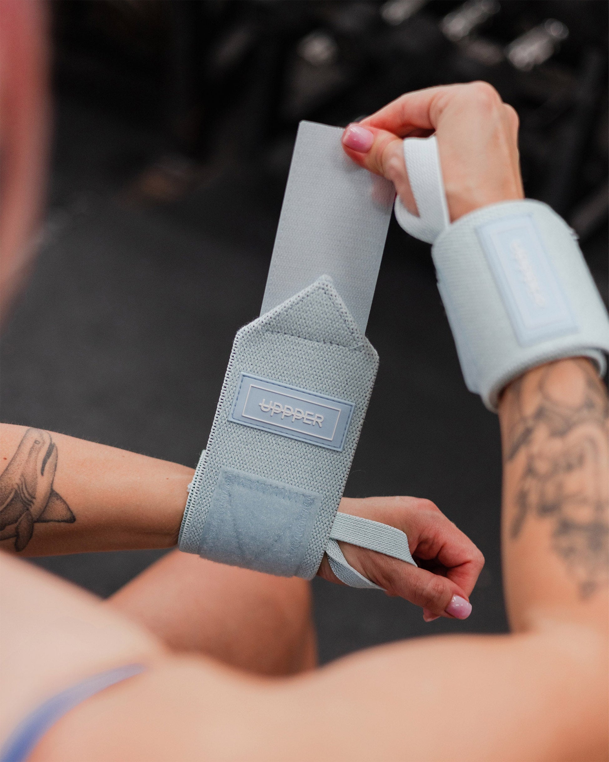 close-up of baby blue uppper wrist wrap showing texture and uppper logo patch