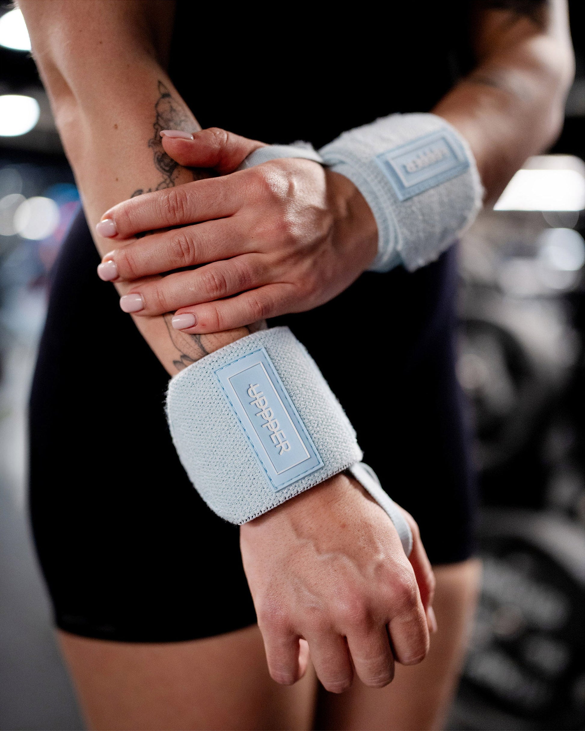 baby blue uppper wrist wraps shown wrapped around wrist with velcro closure visible