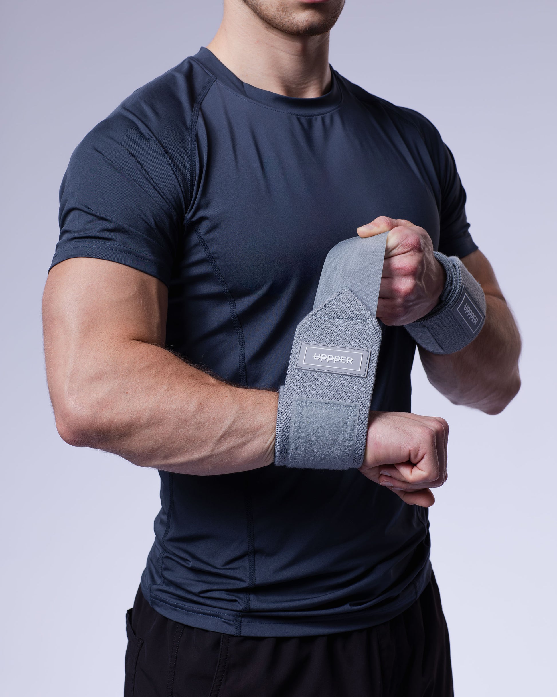 grey uppper wrist wraps shown wrapped around wrist with velcro closure visible