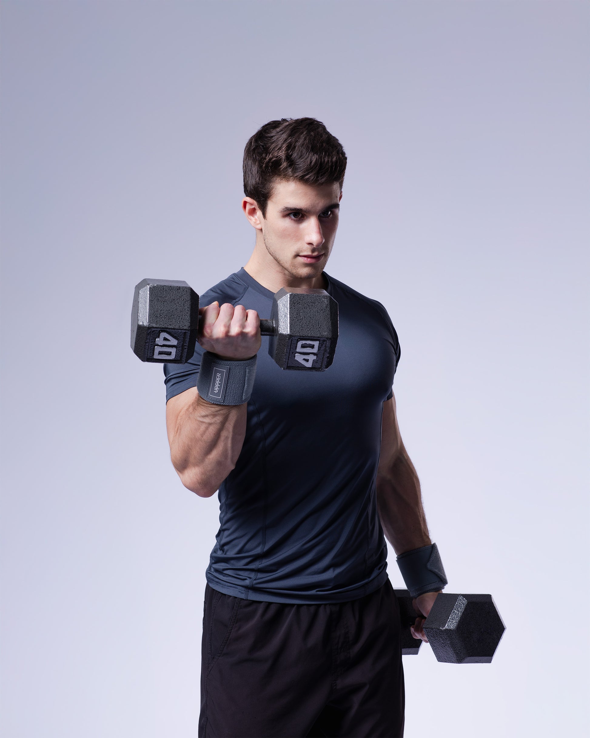 man performing exercise with dumbbell wearing grey uppper wrist wraps
