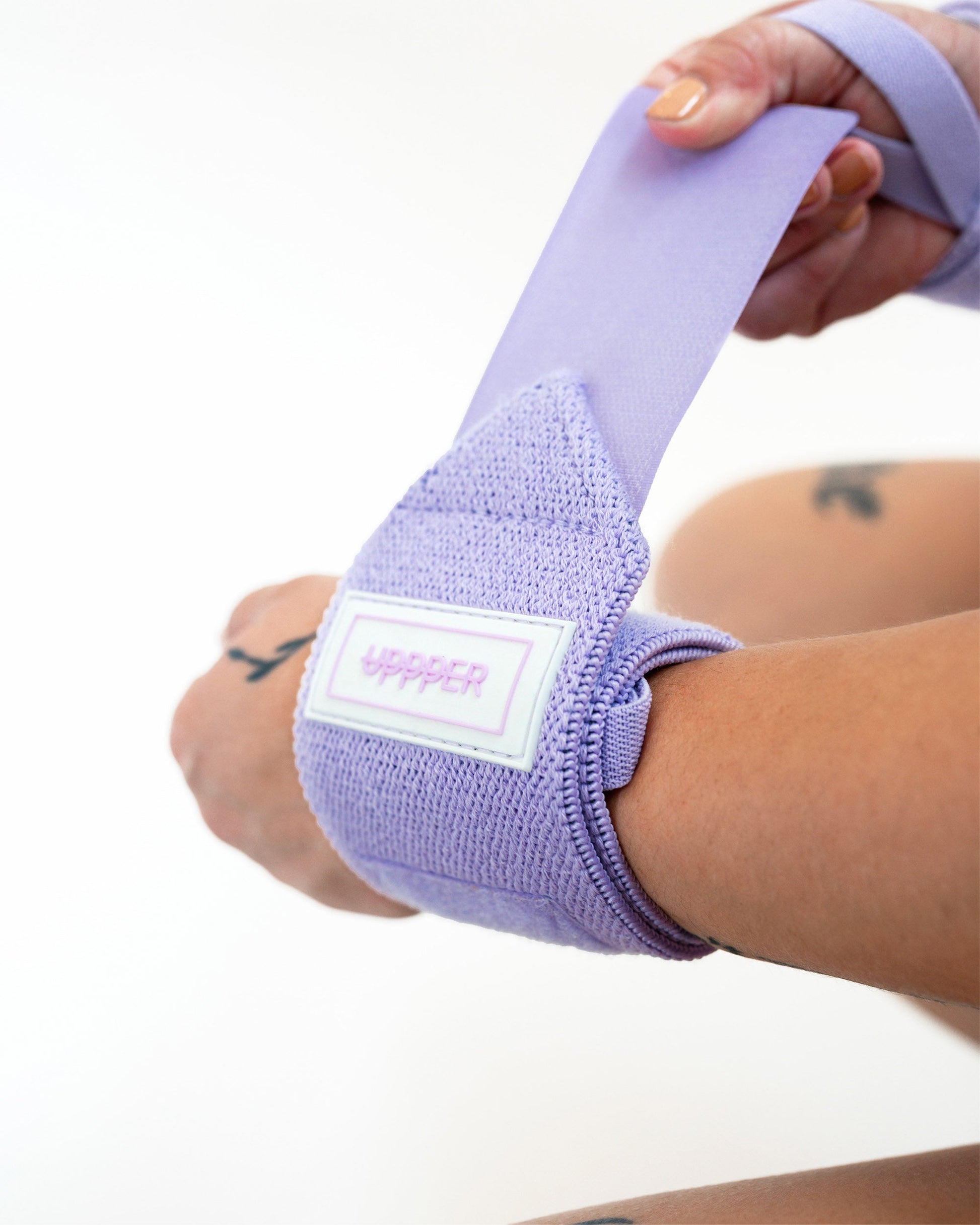 lavender uppper wrist wraps shown wrapped around wrist with velcro closure visible