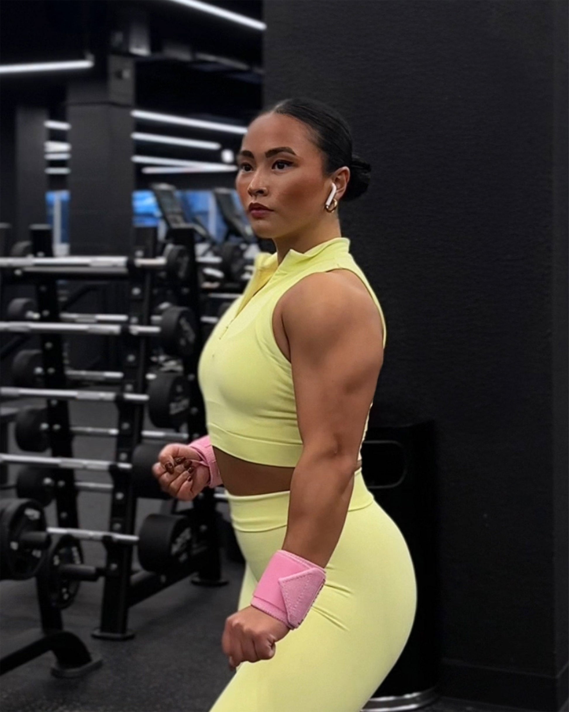 woman posing in pink uppper wrist wraps