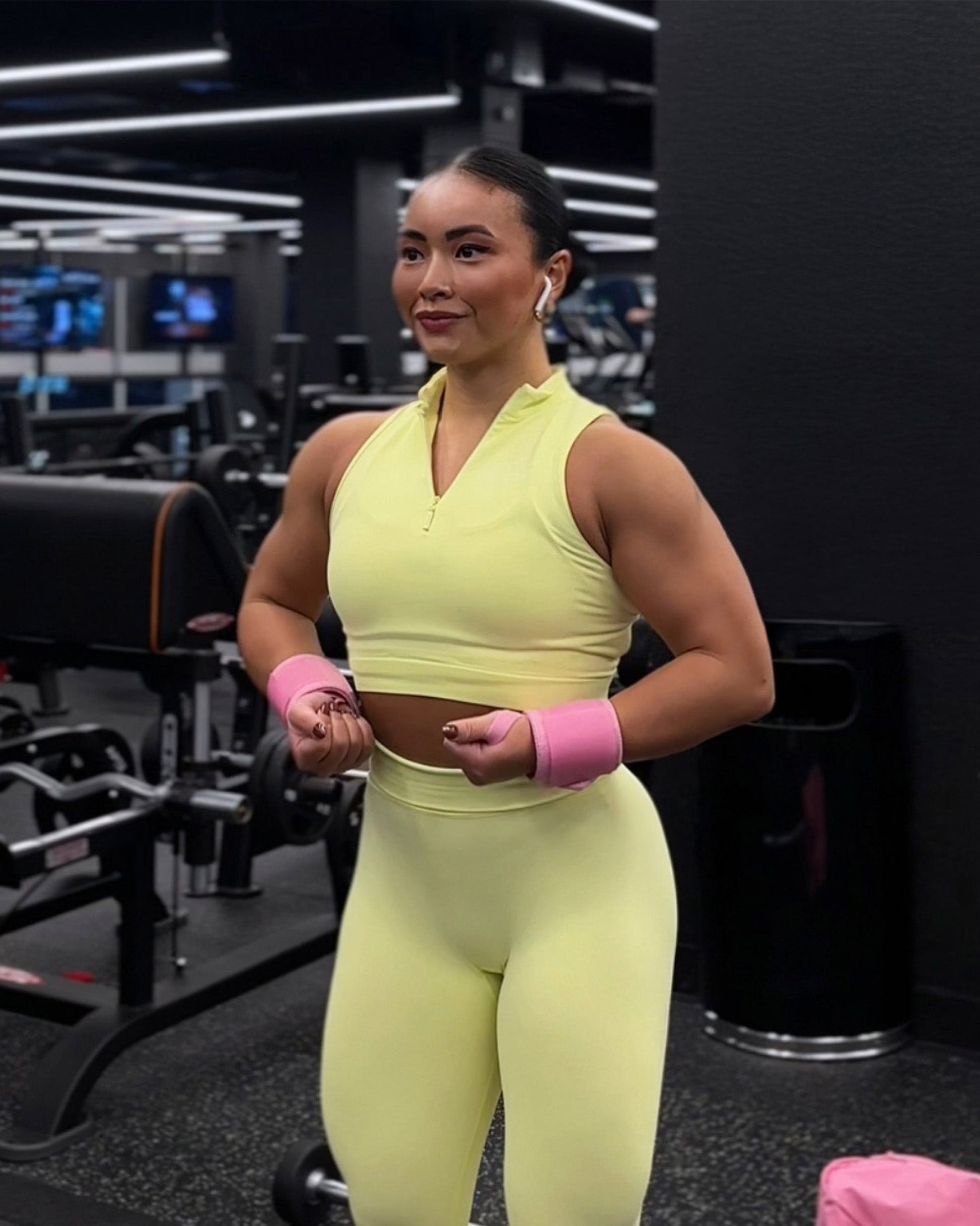 athlete wearing pink uppper wrist wraps shown wrapped around wrist