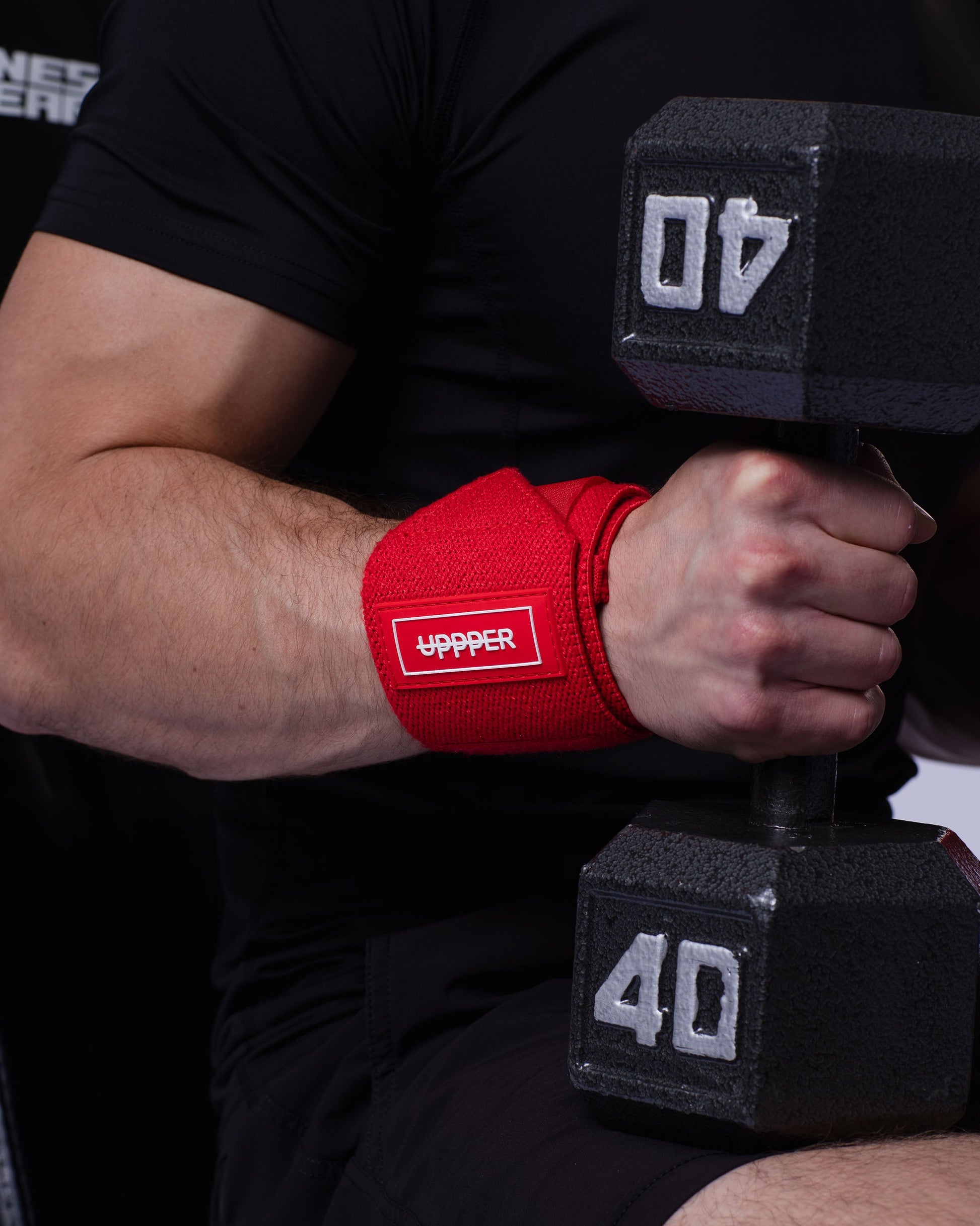 red uppper wrist wraps shown wrapped around wrist with velcro closure visible