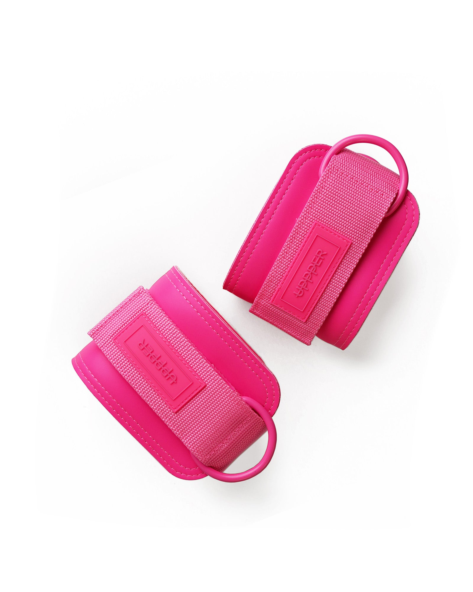 pair of neon pink uppper ankle straps with d-rings and velcro closure on white background