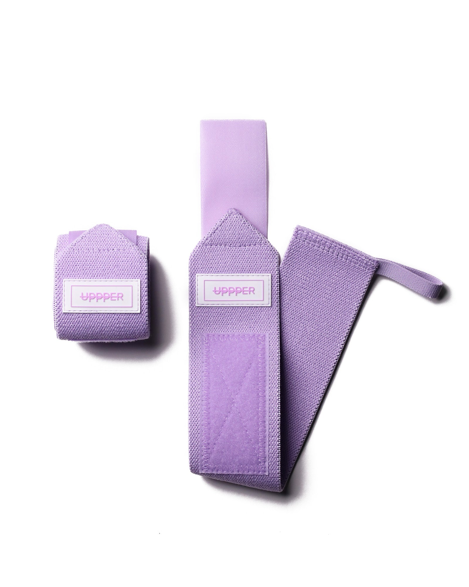 pair of lavender uppper wrist wraps one rolled and one extended on white background