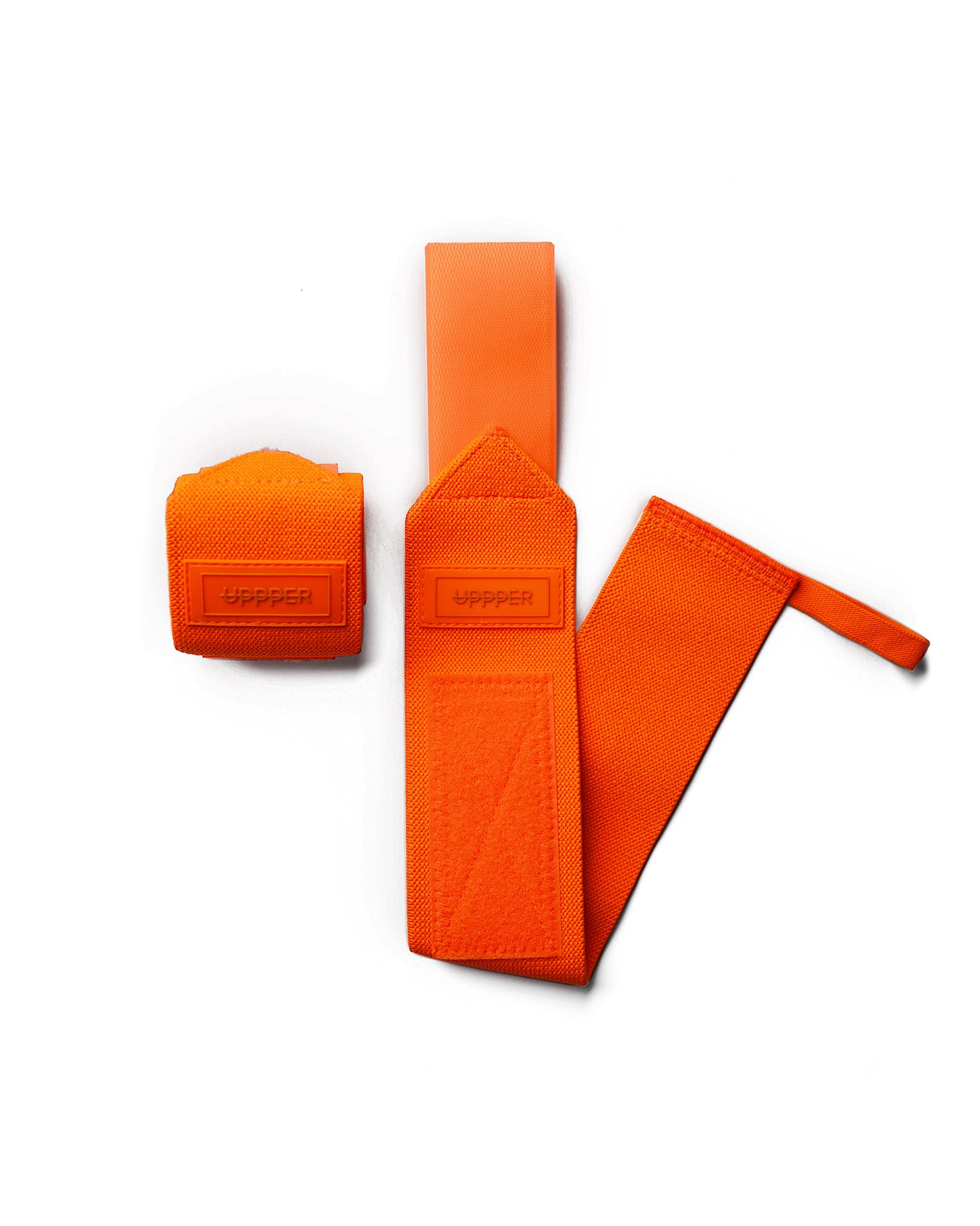pair of neon orange uppper wrist wraps one rolled and one extended on white background